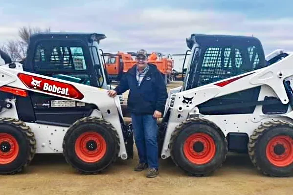 man with two bobcat